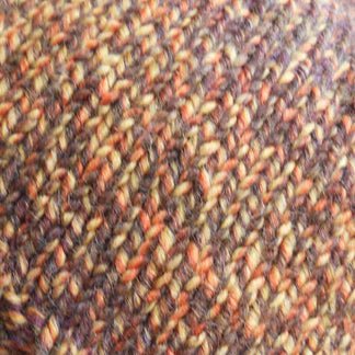 Multicolored knit beanie on a mannequin head against a neutral background