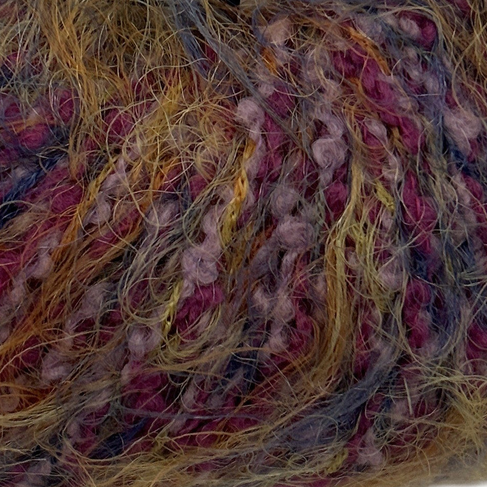 Close-up of multicolored yarn with pink, yellow, and blue threads.