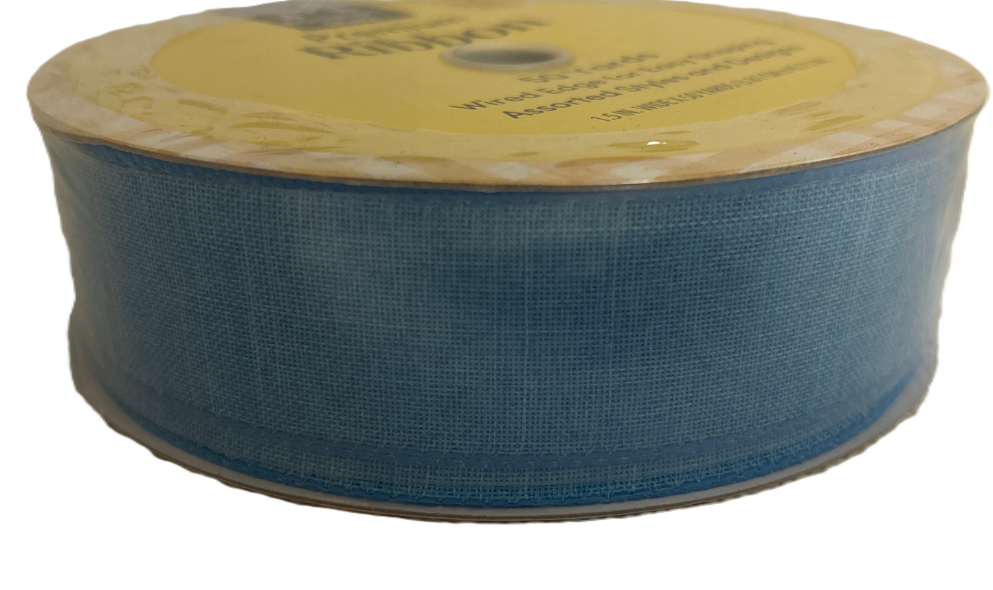Roll of blue ribbon with a yellow label on a white background