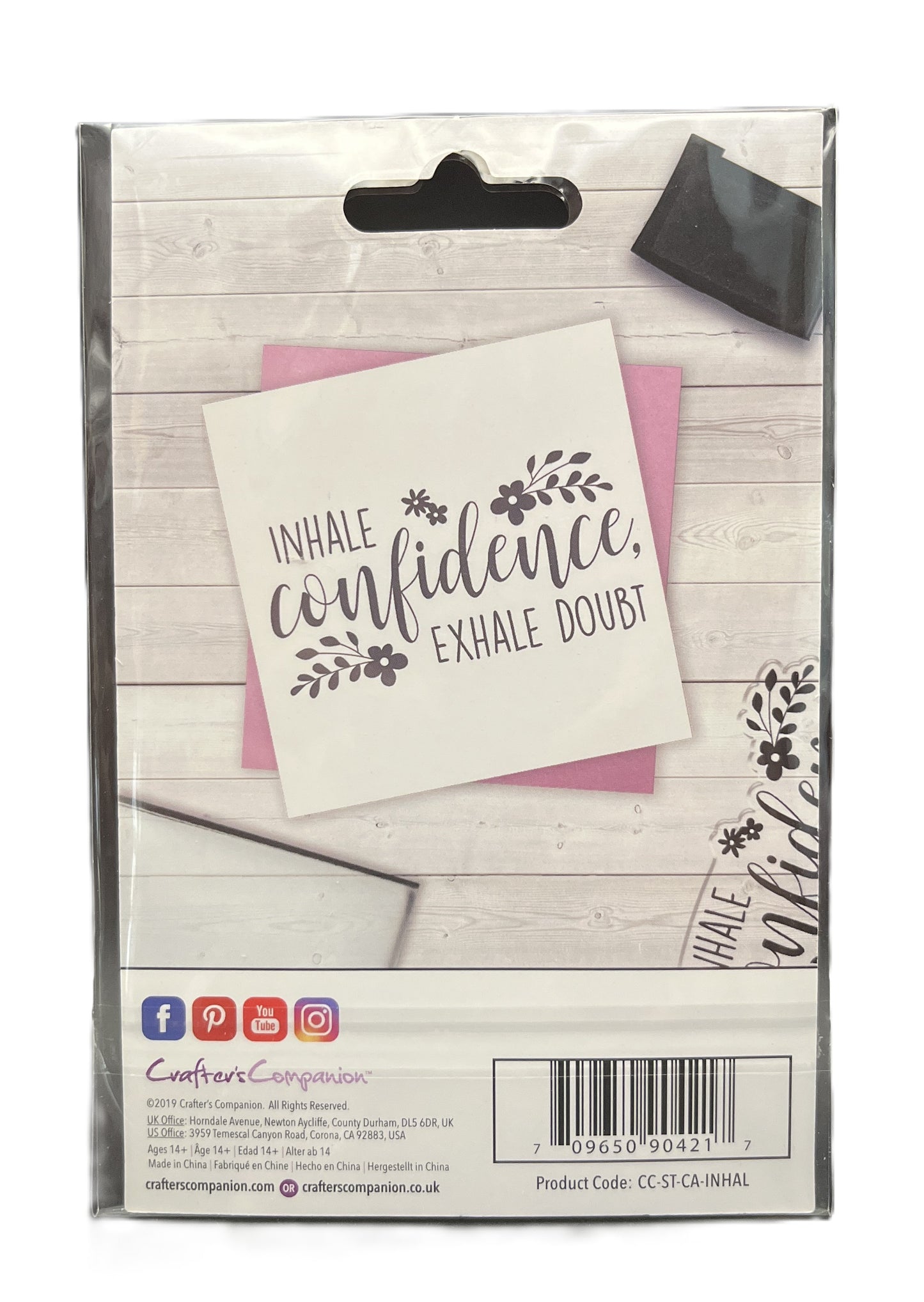 Packaged product with motivational card on a wooden surface
