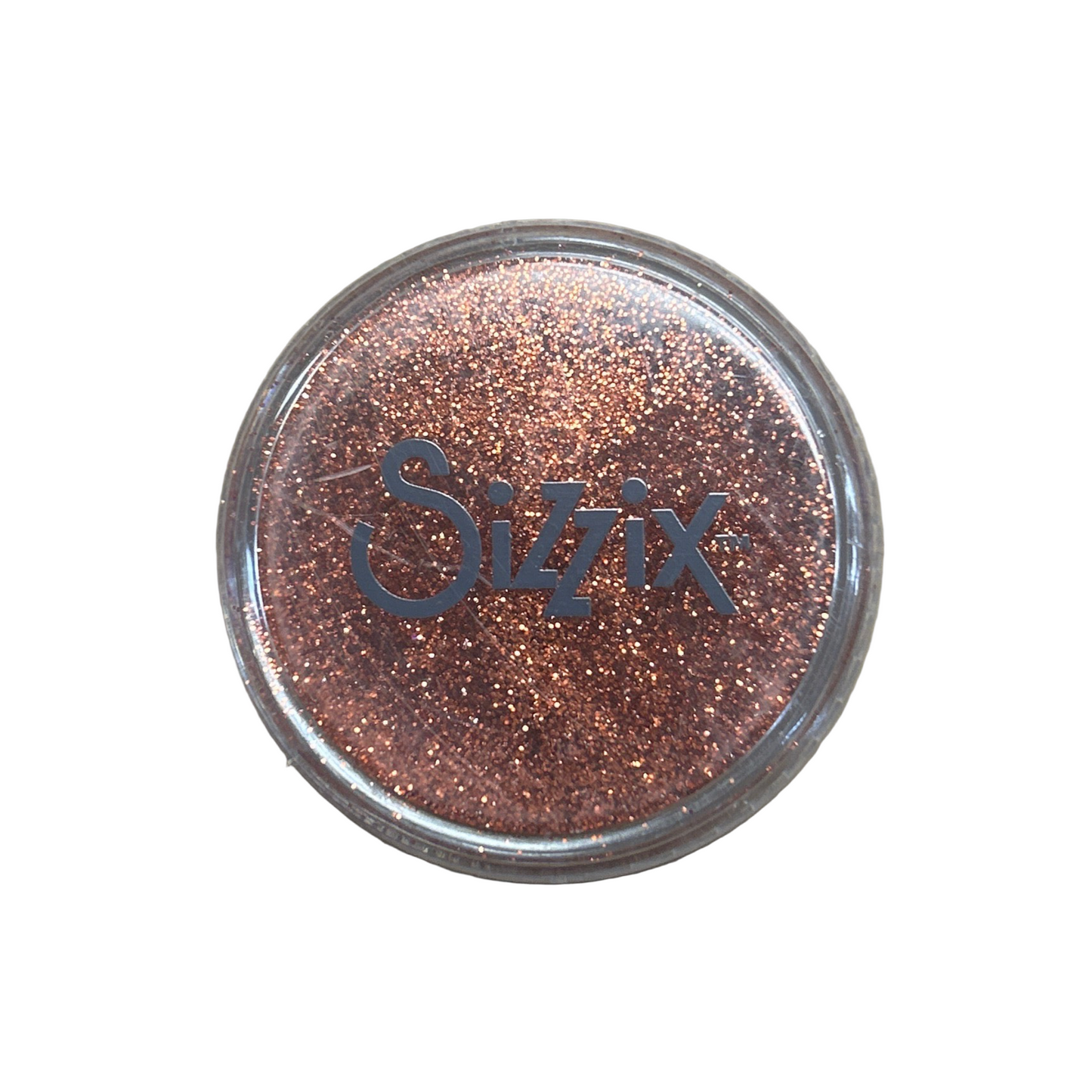 Sizzix glitter container on a beige background