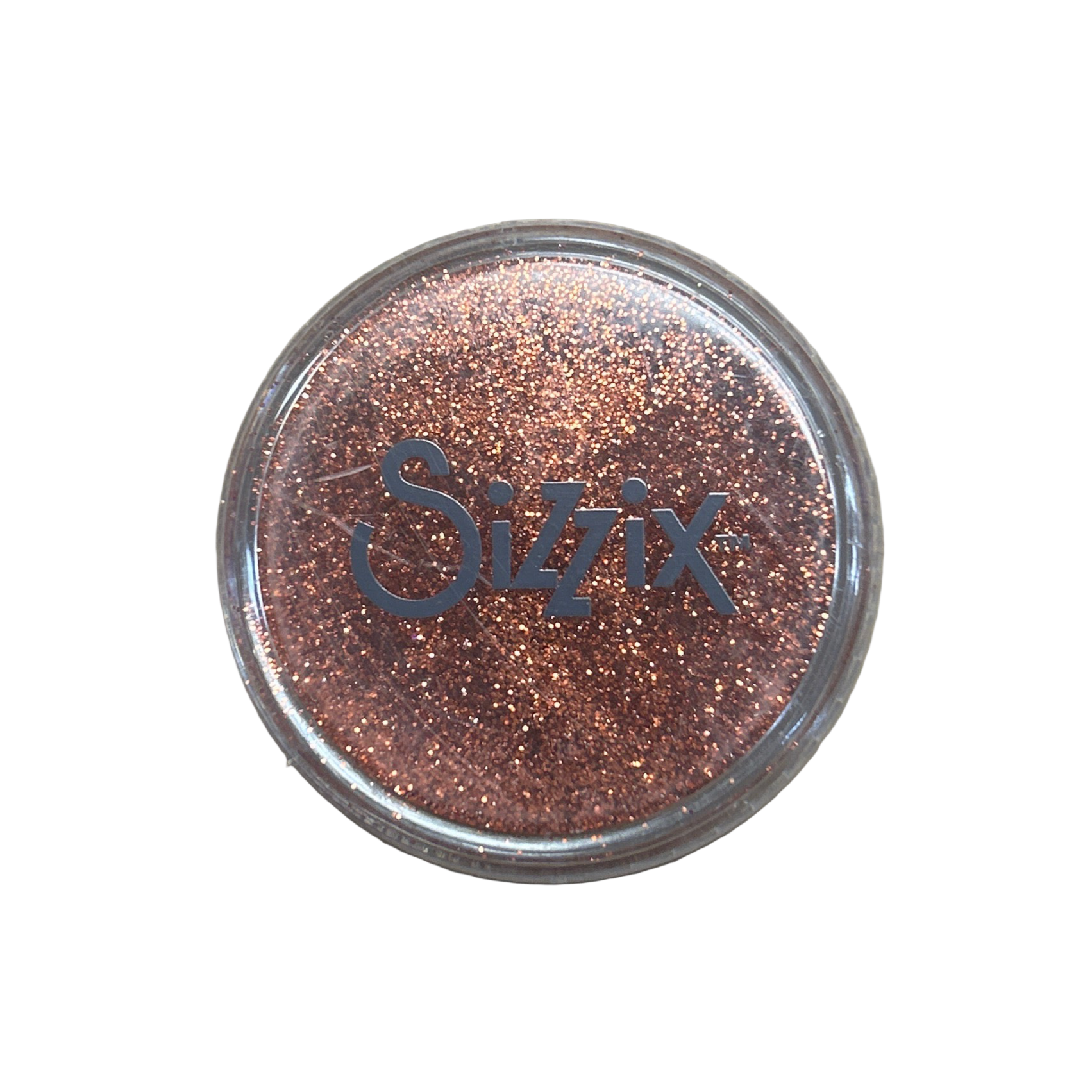 Sizzix glitter container on a beige background