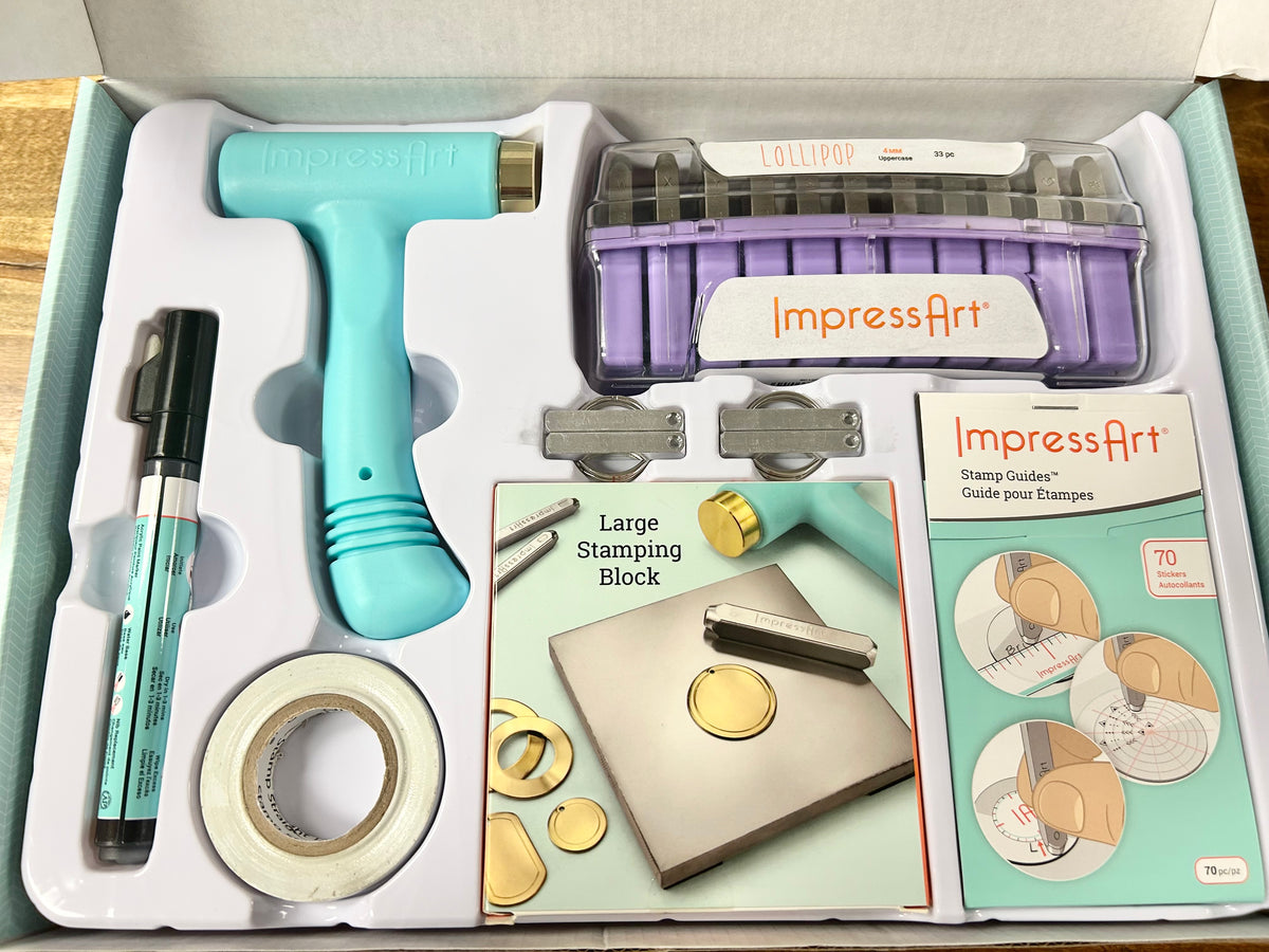 Stamping kit with tools and materials in a box, featuring 'ImpressArt' branding.