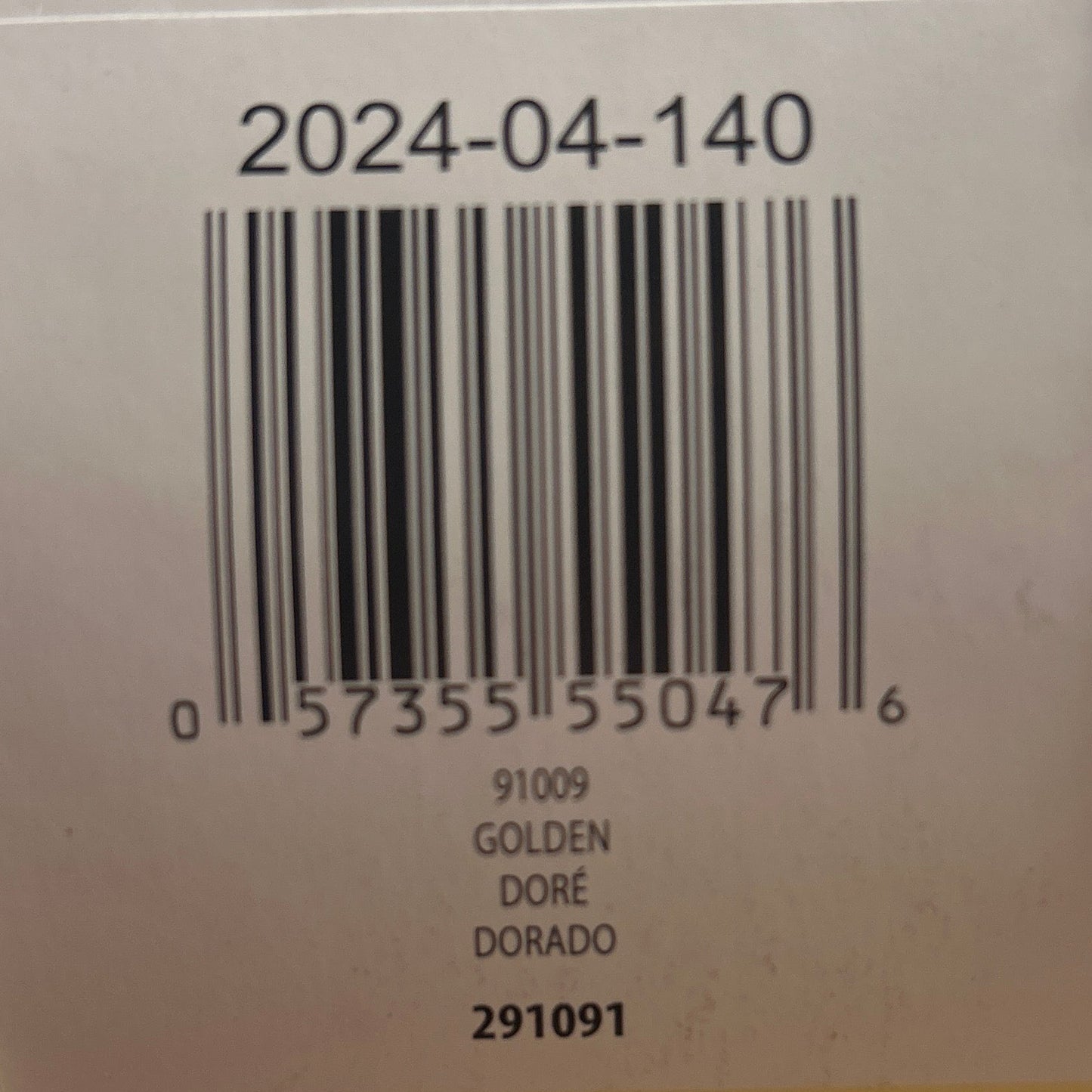 Yarn ball with a label featuring a barcode on a wooden surface