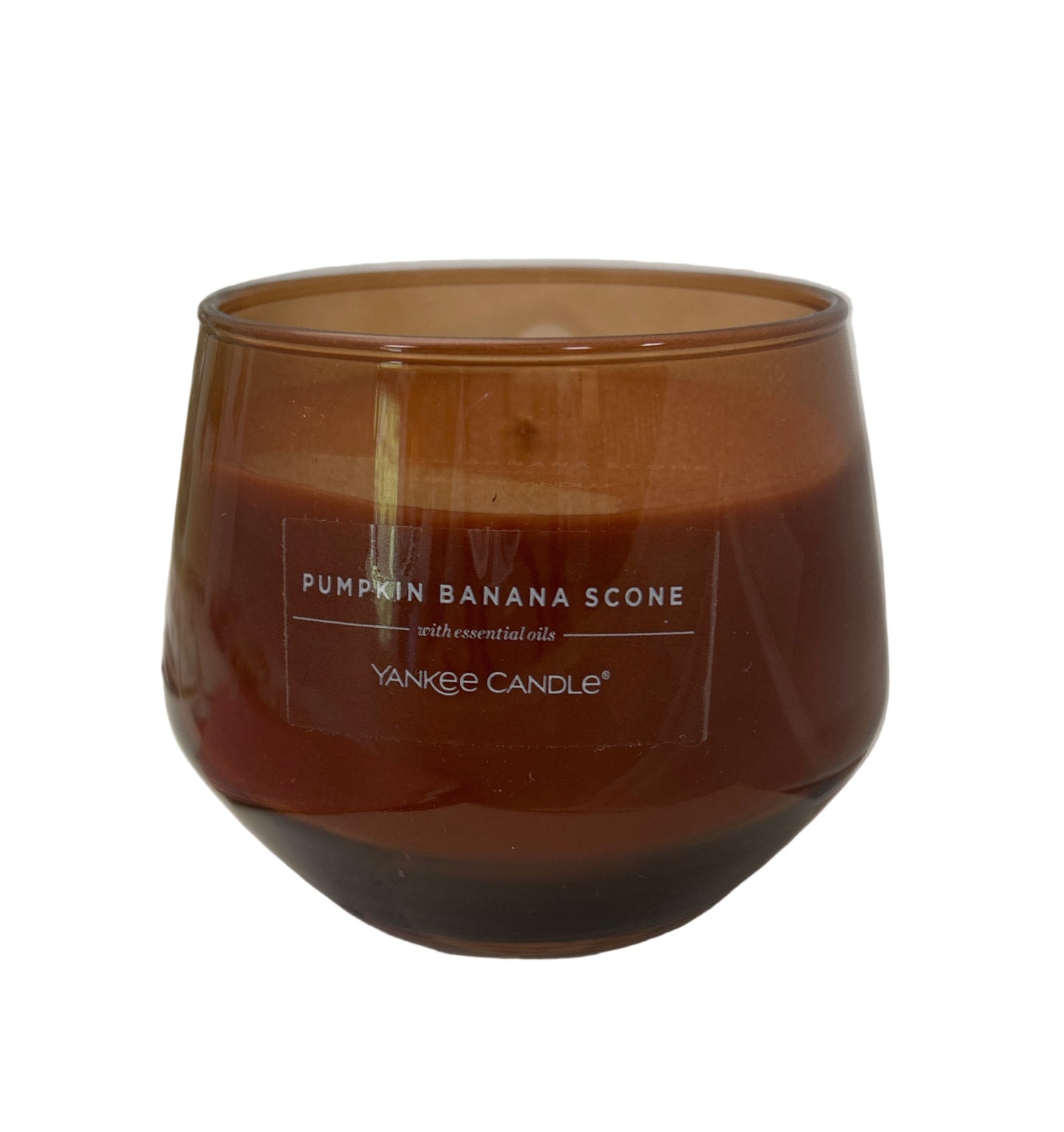 Yankee Candle pumpkin banana scone candle in a brown glass container on a white background