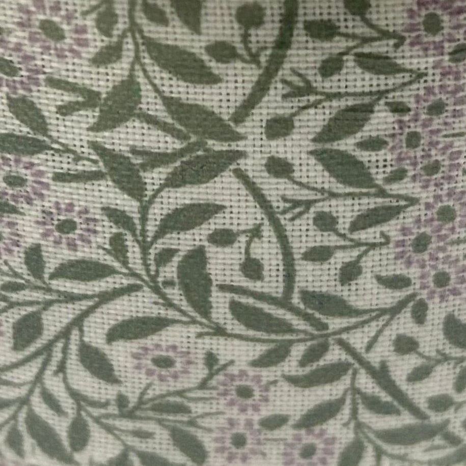 Spool of ribbon with floral pattern on a white background