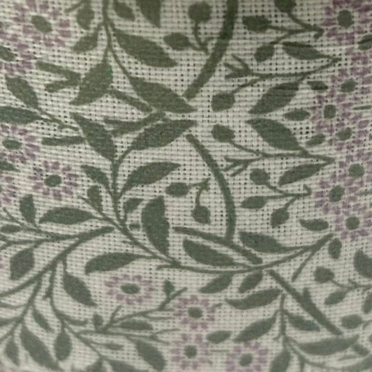 Spool of ribbon with floral pattern on a white background