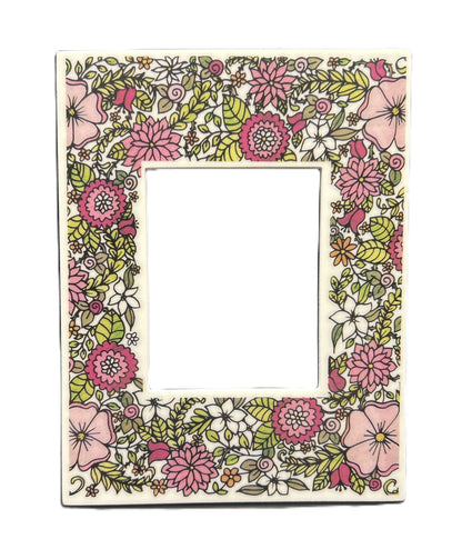 Floral patterned frame with pink, green, and white flowers on a white background