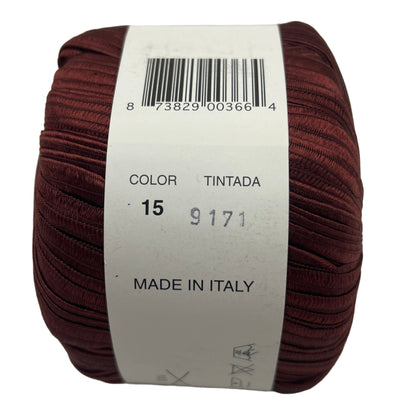 Brown yarn ball with a label on a light gray background