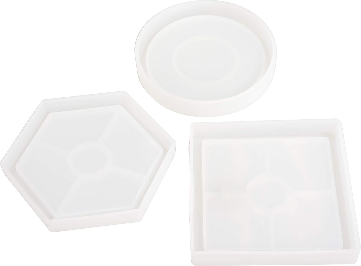 Set of three white ceramic trays with different shapes on a white background