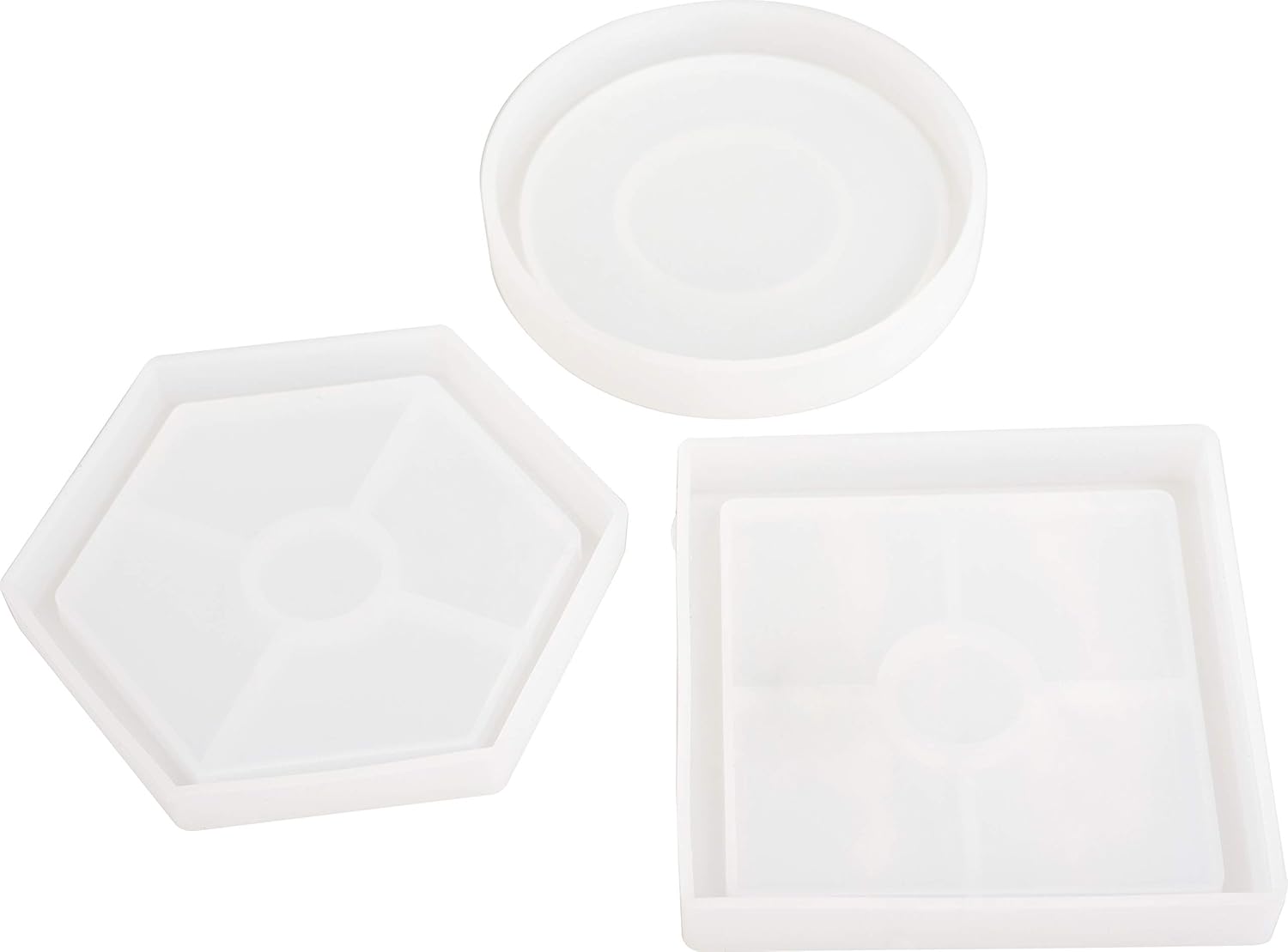 Set of three white ceramic trays with different shapes on a white background