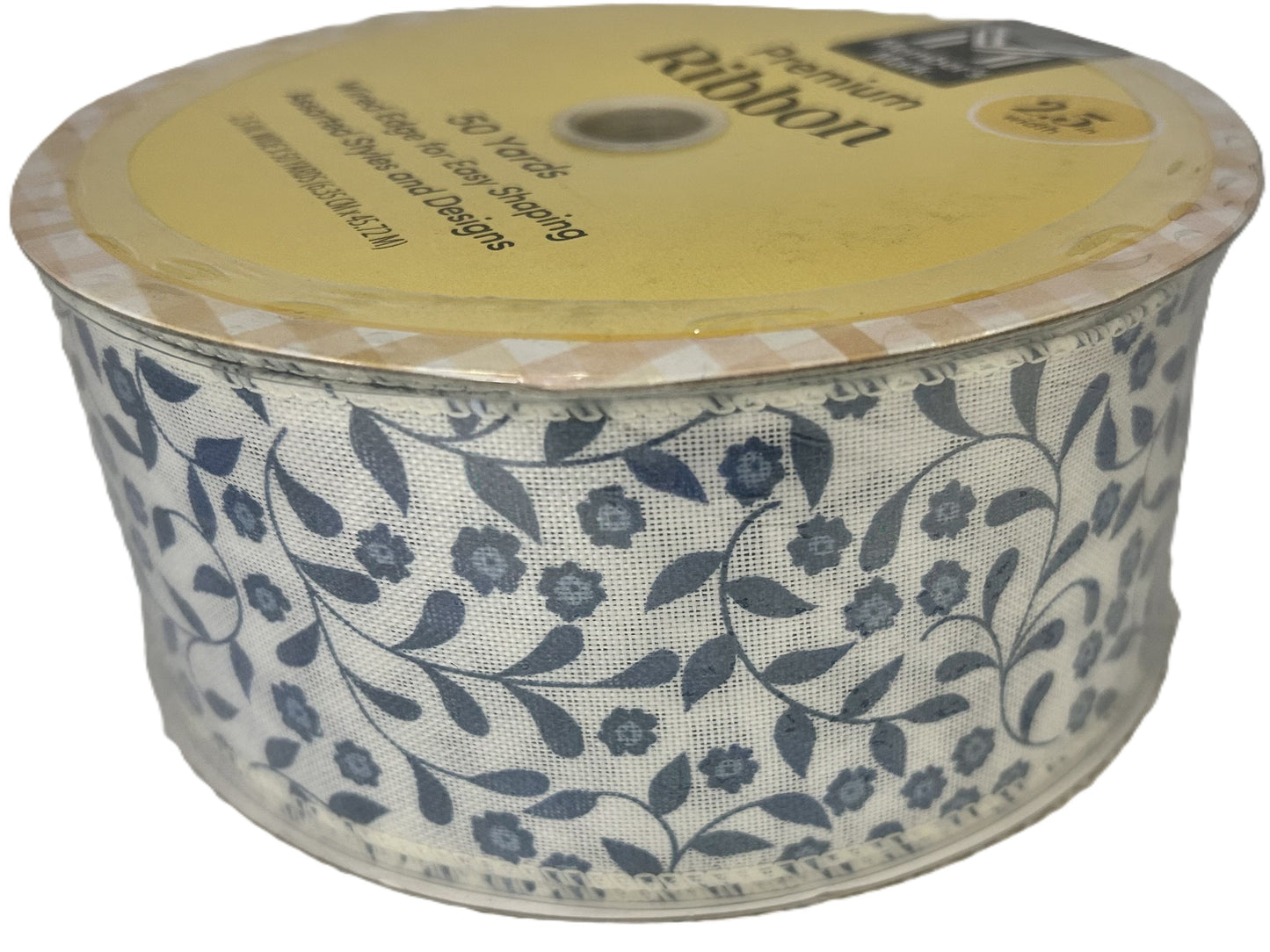 Spool of floral ribbon with a yellow label on a white background