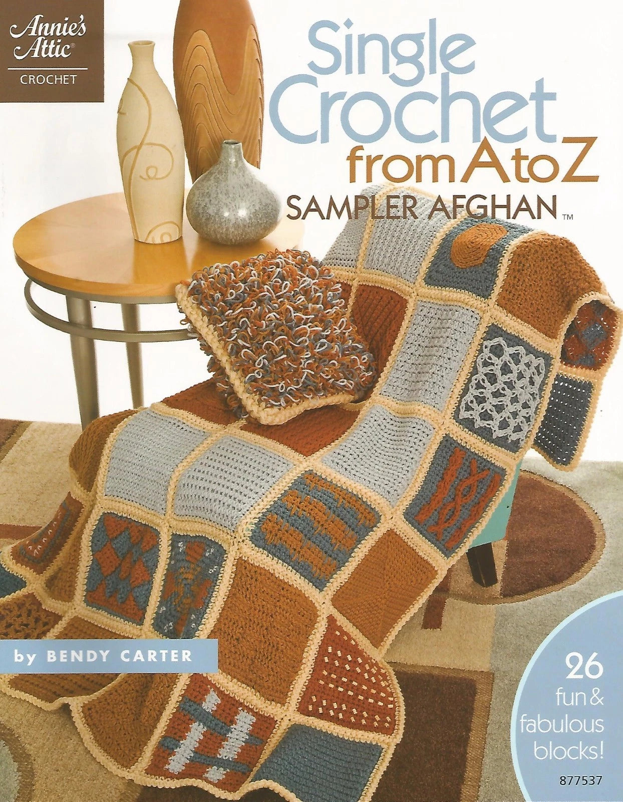 Crocheted Afghan with Colorful Squares on a Couch, Book Cover of 'Single Crochet from A to Z Sampler Afghan' by Annie's Attic