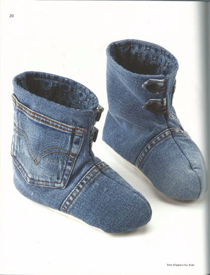Pair of denim baby booties on a white background
