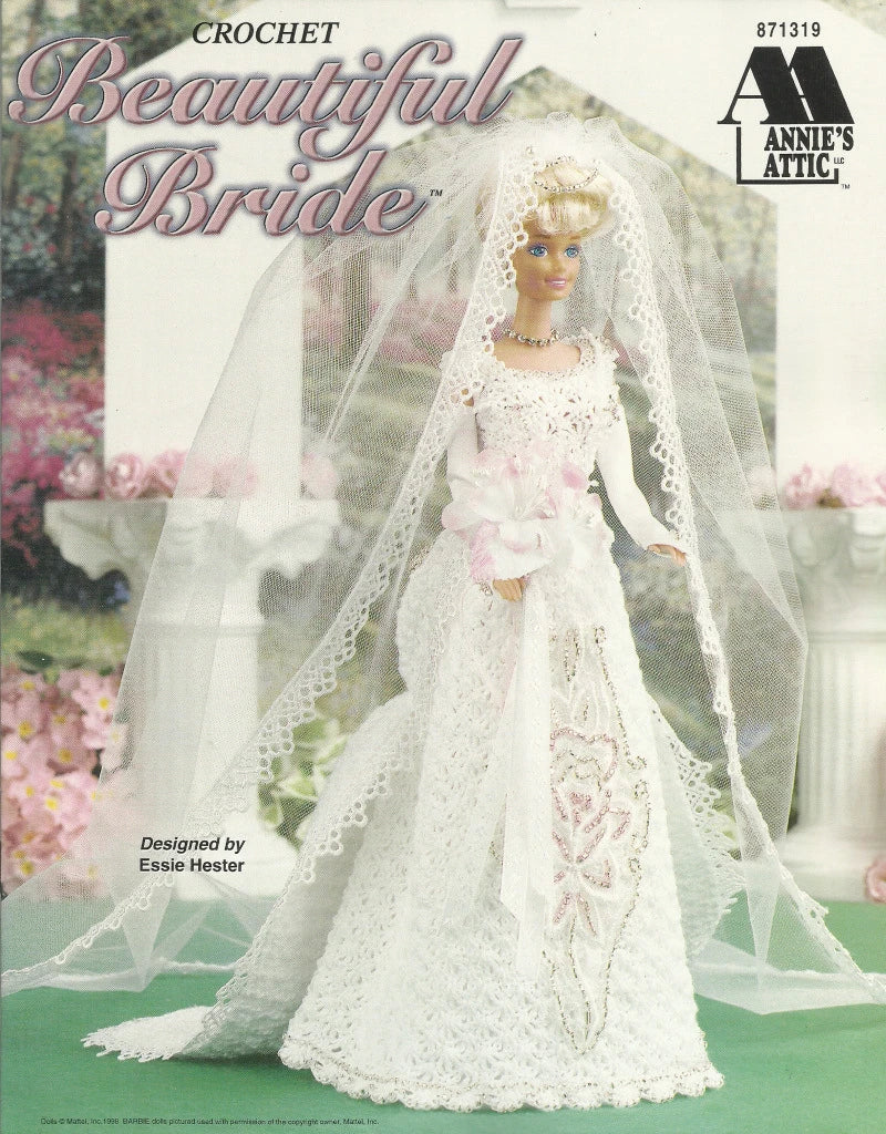 Crocheted wedding dress and veil on a doll with 'Annie's Attic' branding