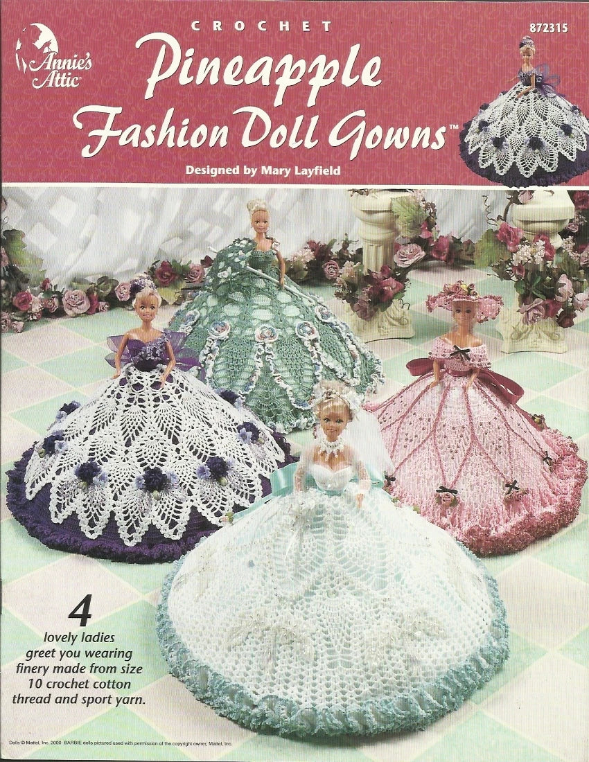 Crochet pattern book for Pineapple Fashion Doll Gowns by Annie's Attic with dolls and gowns on a pink background.