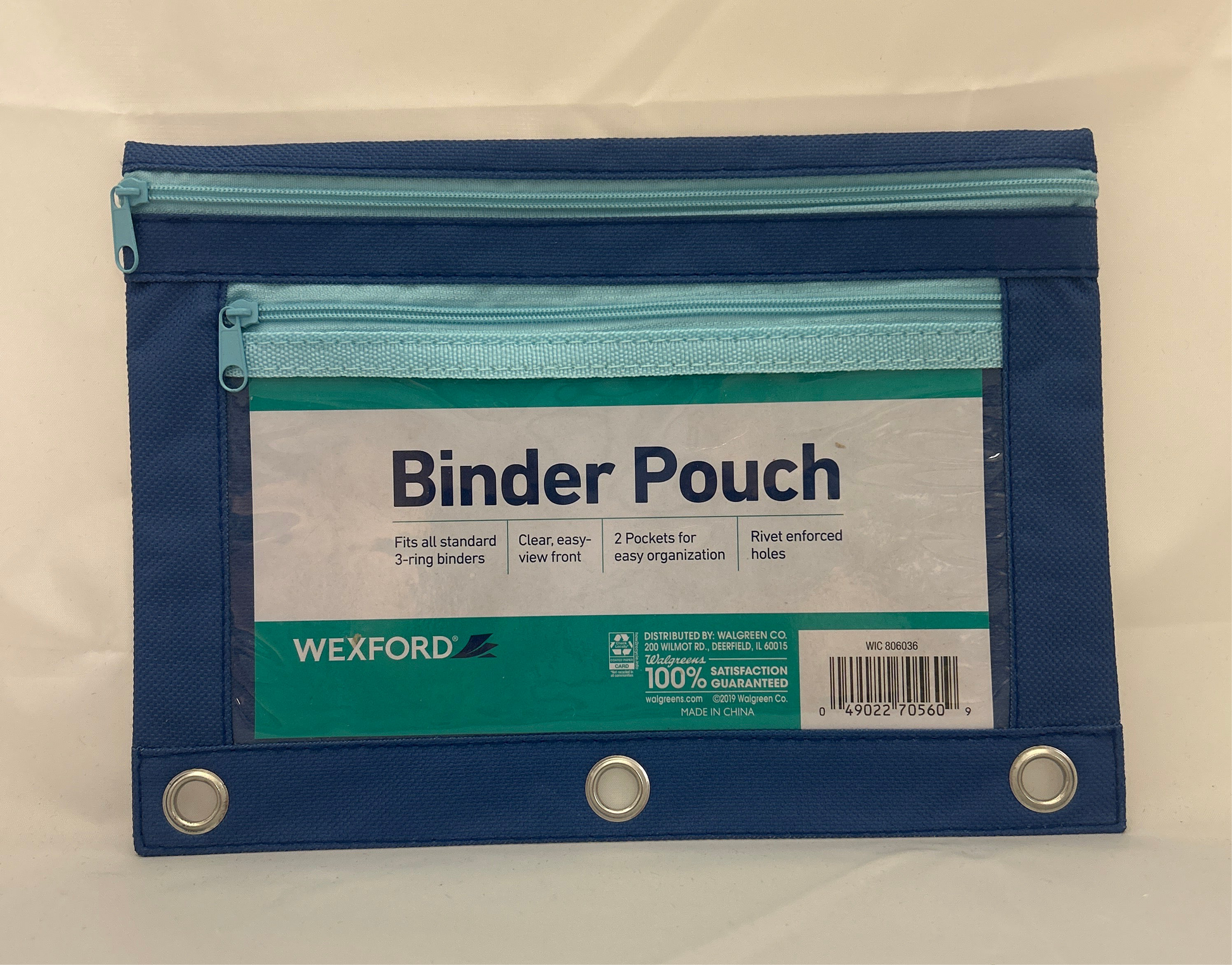 Blue and green binder pouch with Wexford branding on a beige background