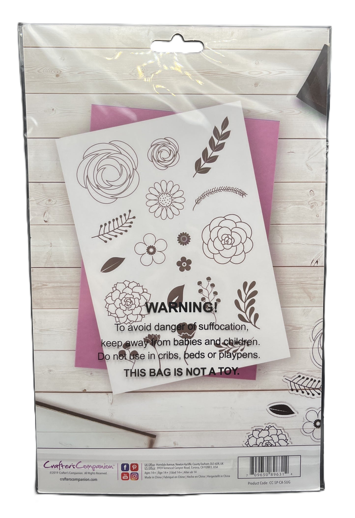 Packaging of a stamp set with floral designs on a wooden surface