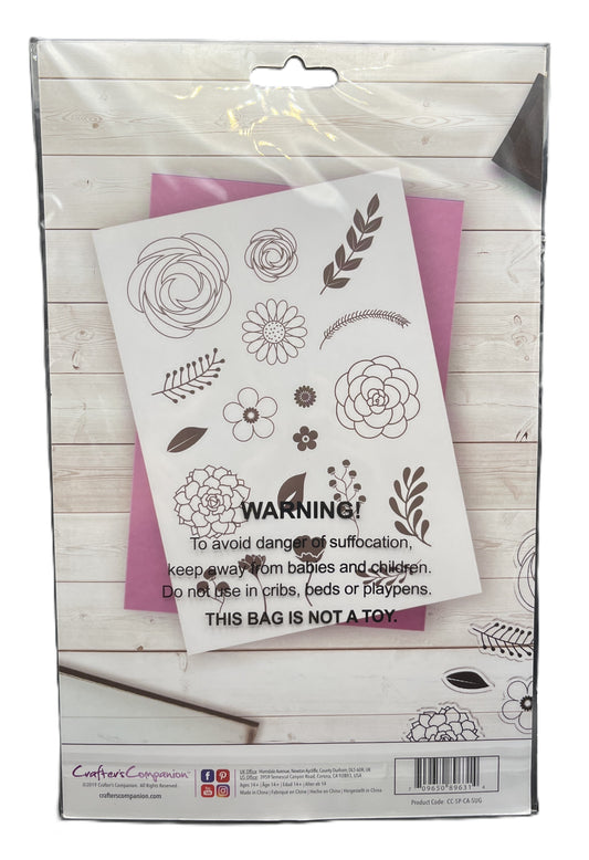 Packaging of a stamp set with floral designs on a wooden surface
