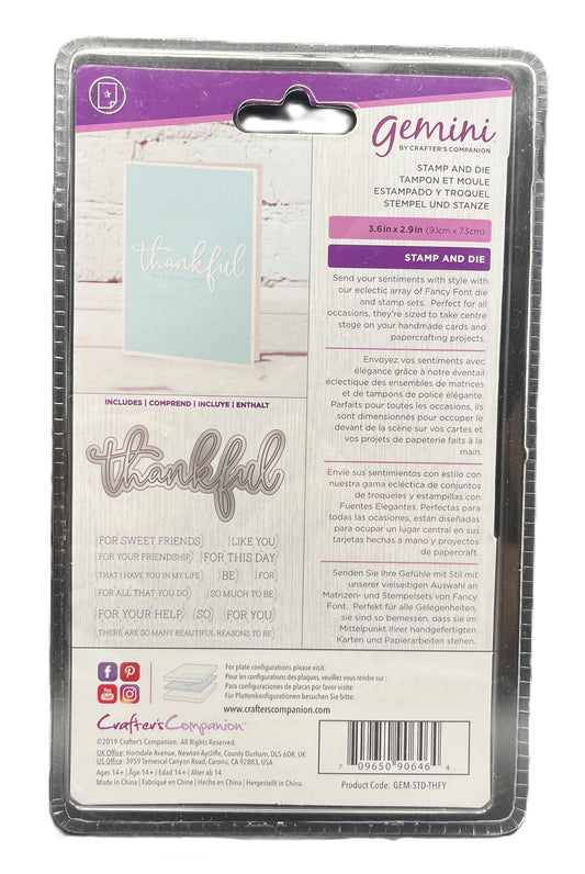 Package of Gemini stamp and die set with 'thankful' text on a wooden surface.