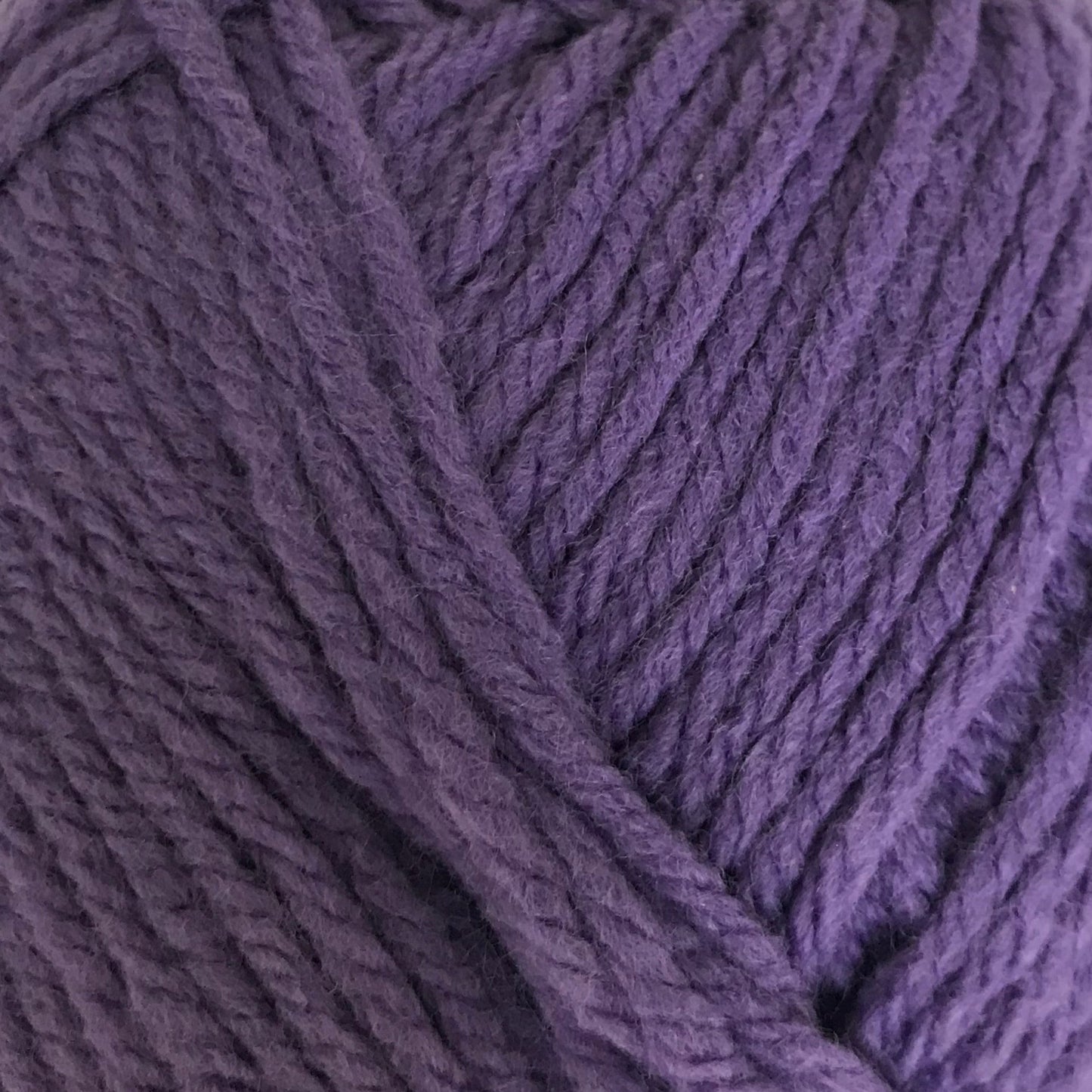 Purple ball of yarn on a white background