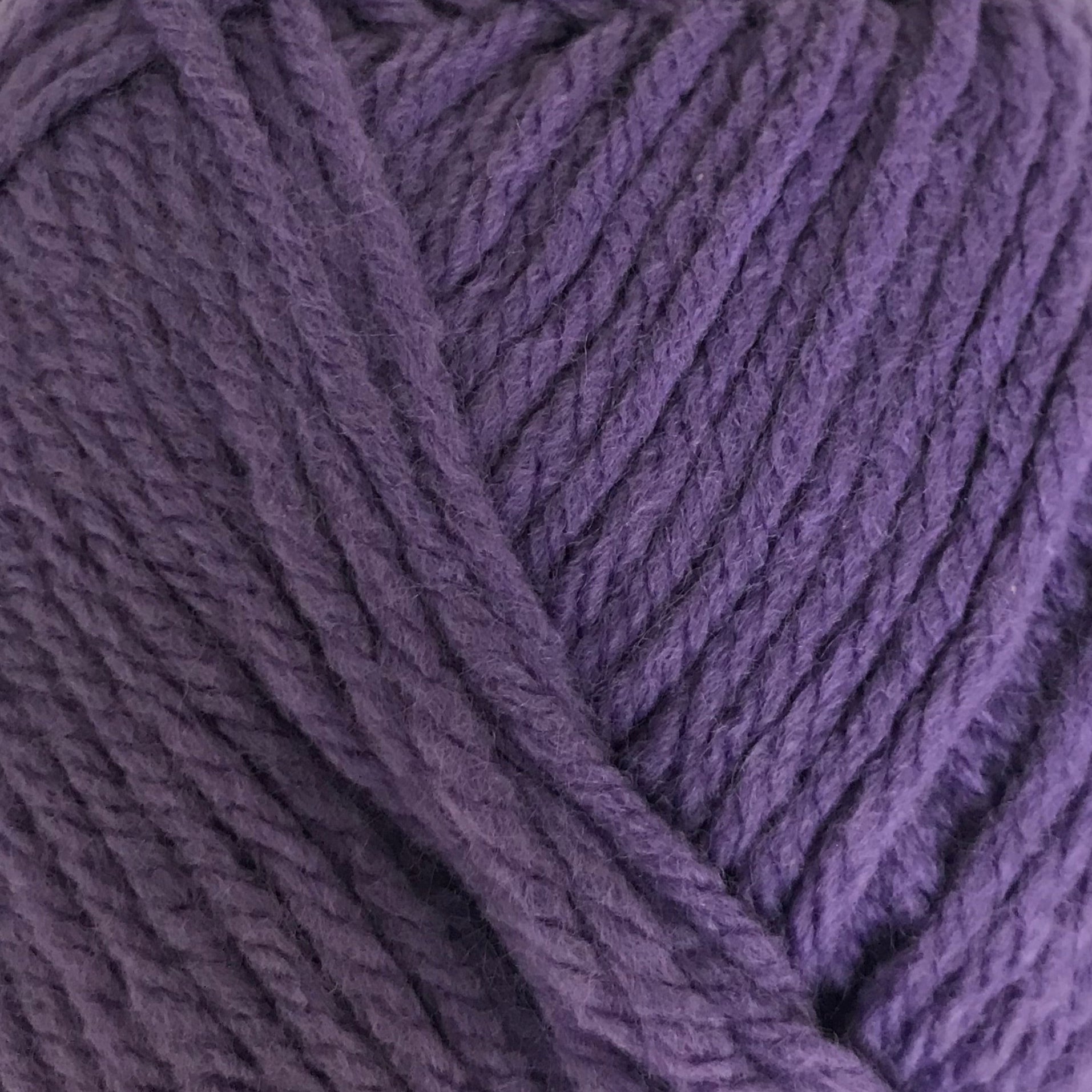 Purple ball of yarn on a white background