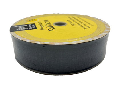 Spool of black ribbon with a yellow label on a white background