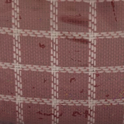 Close-up of a fabric with a plaid pattern in shades of brown and beige.