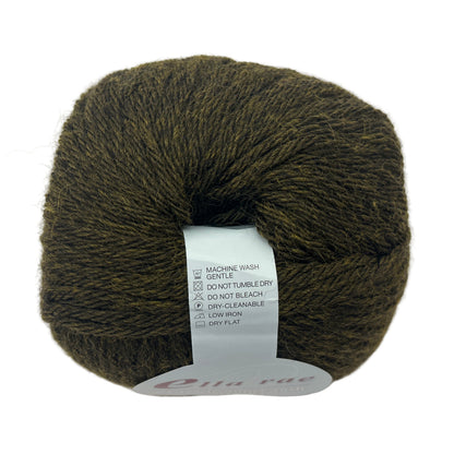 Ball of dark green yarn with a label on a white background