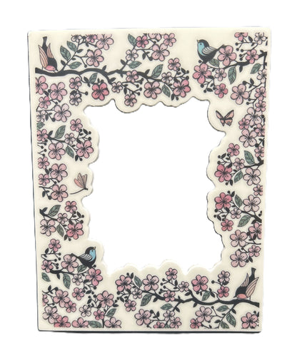 Decorative letter 'L' with floral patterns and birds on a white background