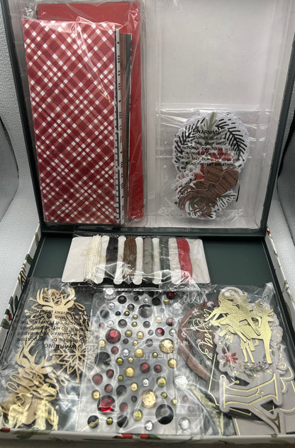 Collection of decorative items including buttons, ribbons, and a ruler in an open box.