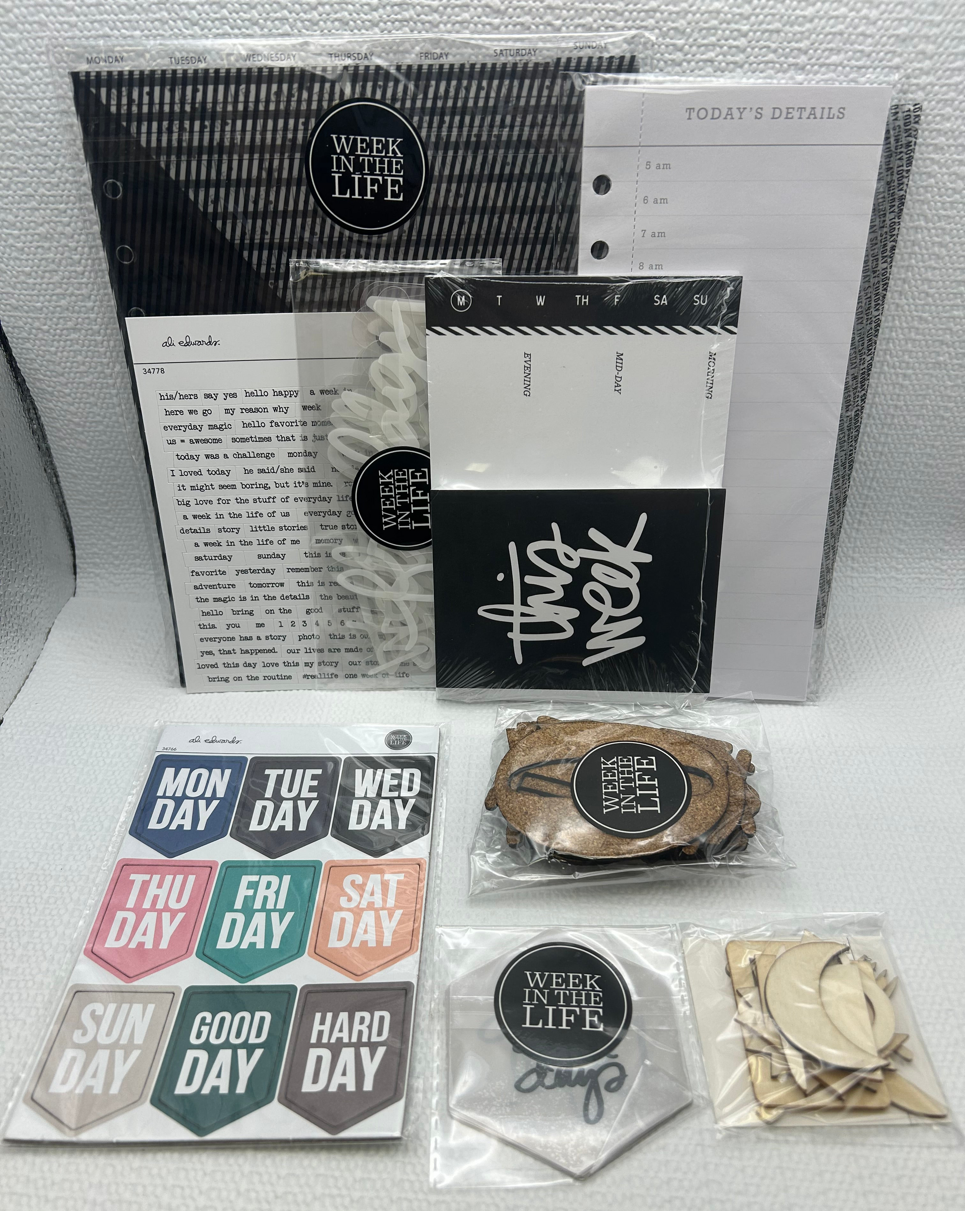 Collection of planner accessories including a weekly planner, stickers, and other small items on a white surface.