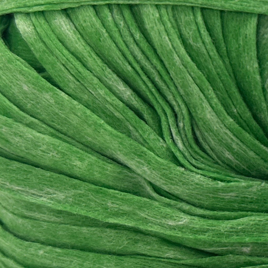 Green ball of yarn with a label on a white background