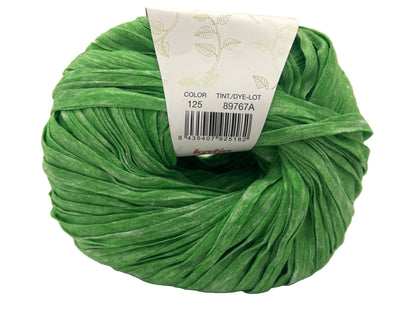 Green ball of yarn with a label on a white background