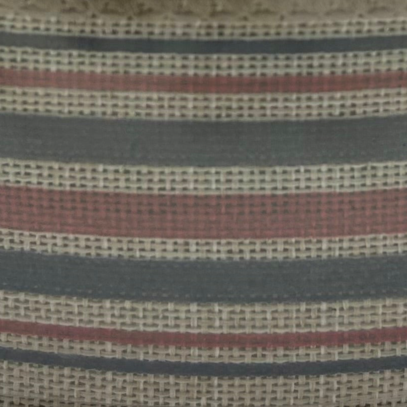 Close-up of striped fabric with red, blue, and beige colors.