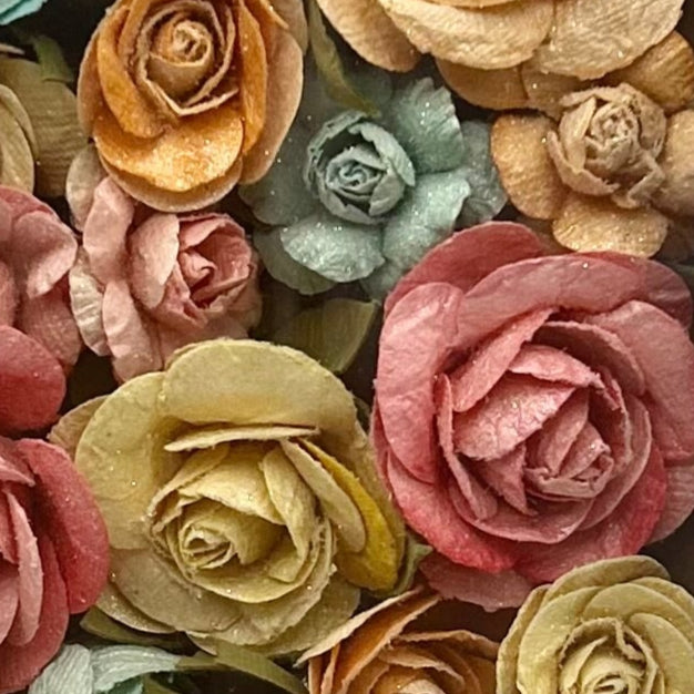 Close-up of colorful paper flowers in various shades.