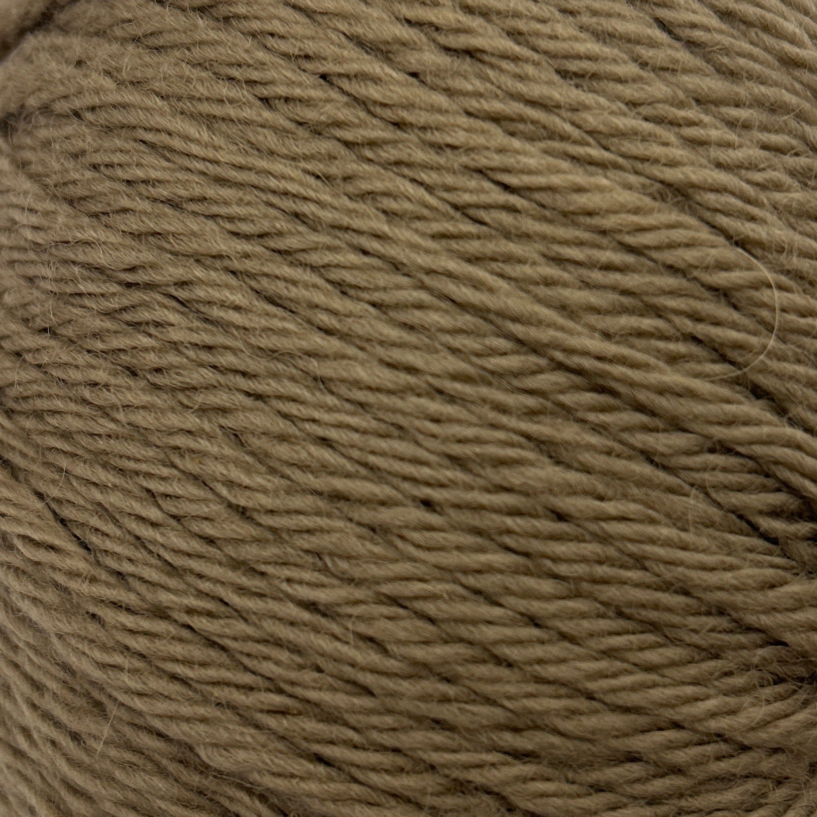 Ball of brown yarn on a white background