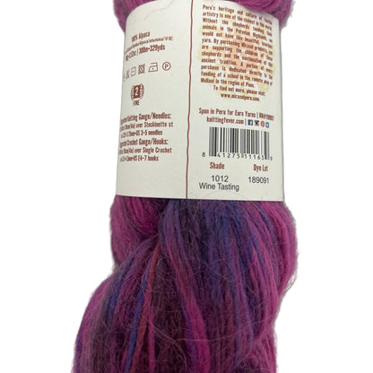Purple yarn skein with a label on a white background