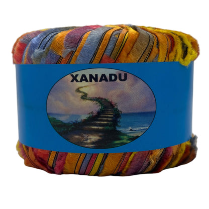Colorful yarn ball with a blue label featuring the brand 'Xanadu' on a white background