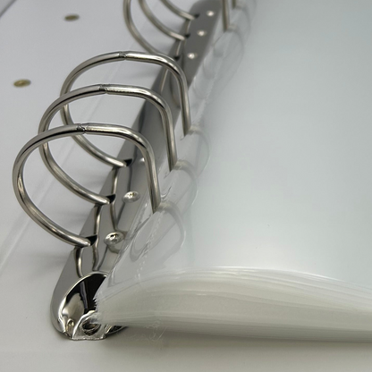 Close-up of a white notebook with metal rings on a white background