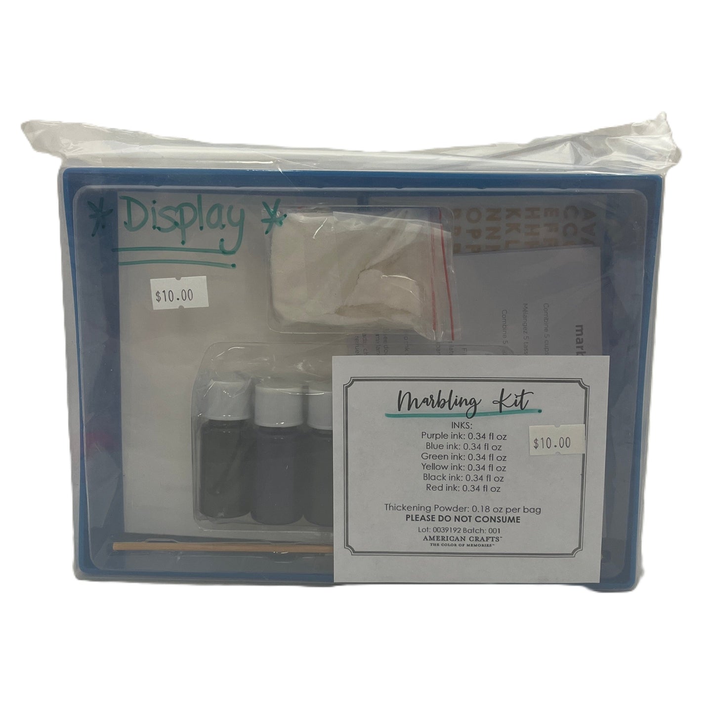 Marbling kit packaging with ink bottles and tools on a white background