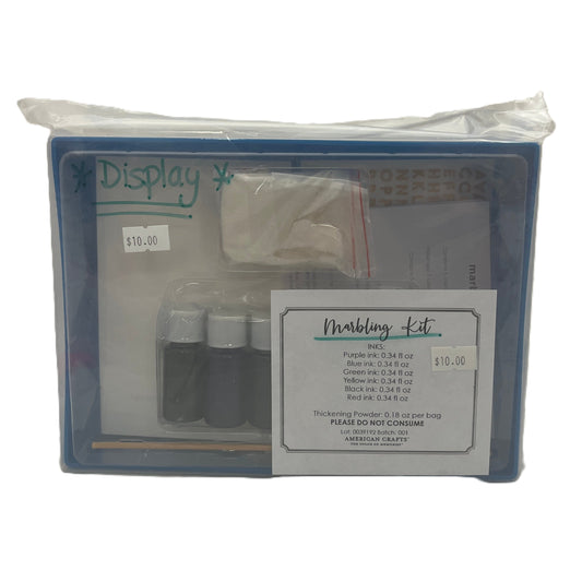 Marbling kit packaging with ink bottles and tools on a white background