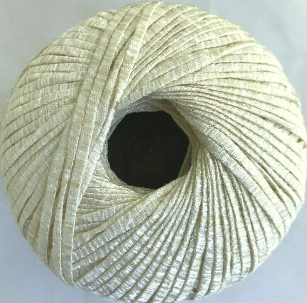Close-up of a ball of beige thread on a light gray background