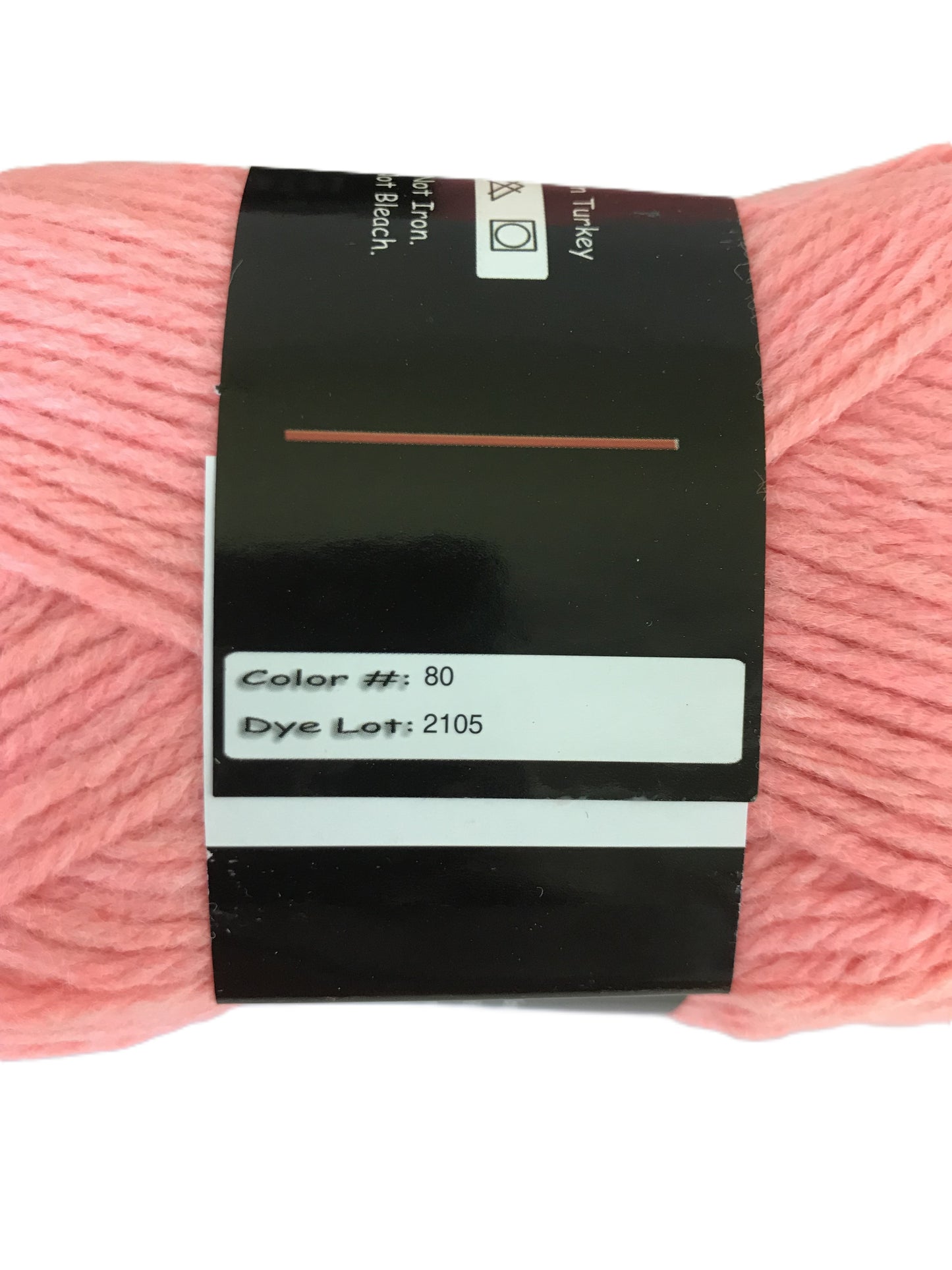 Ball of pink yarn with a label on a white background