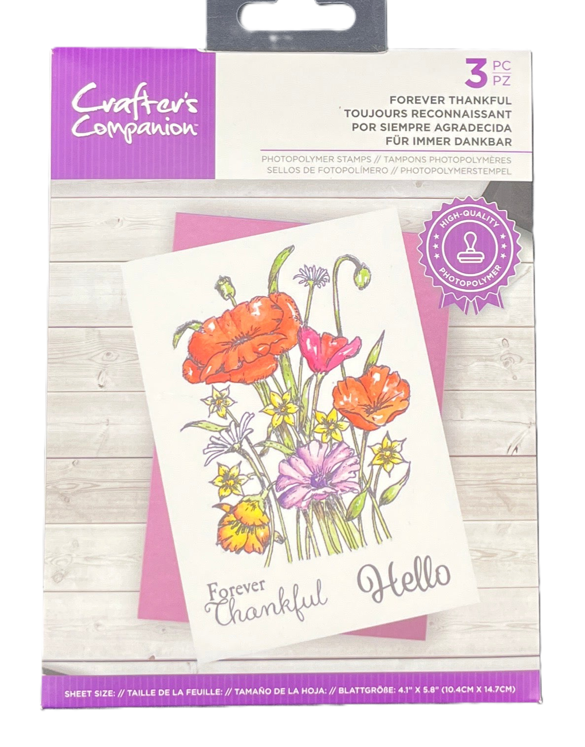 Packaged floral stamp set with 'Forever Thankful Hello' text on a wooden surface