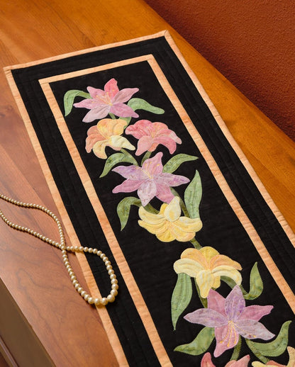 Decorative table runner with floral design on a wooden surface