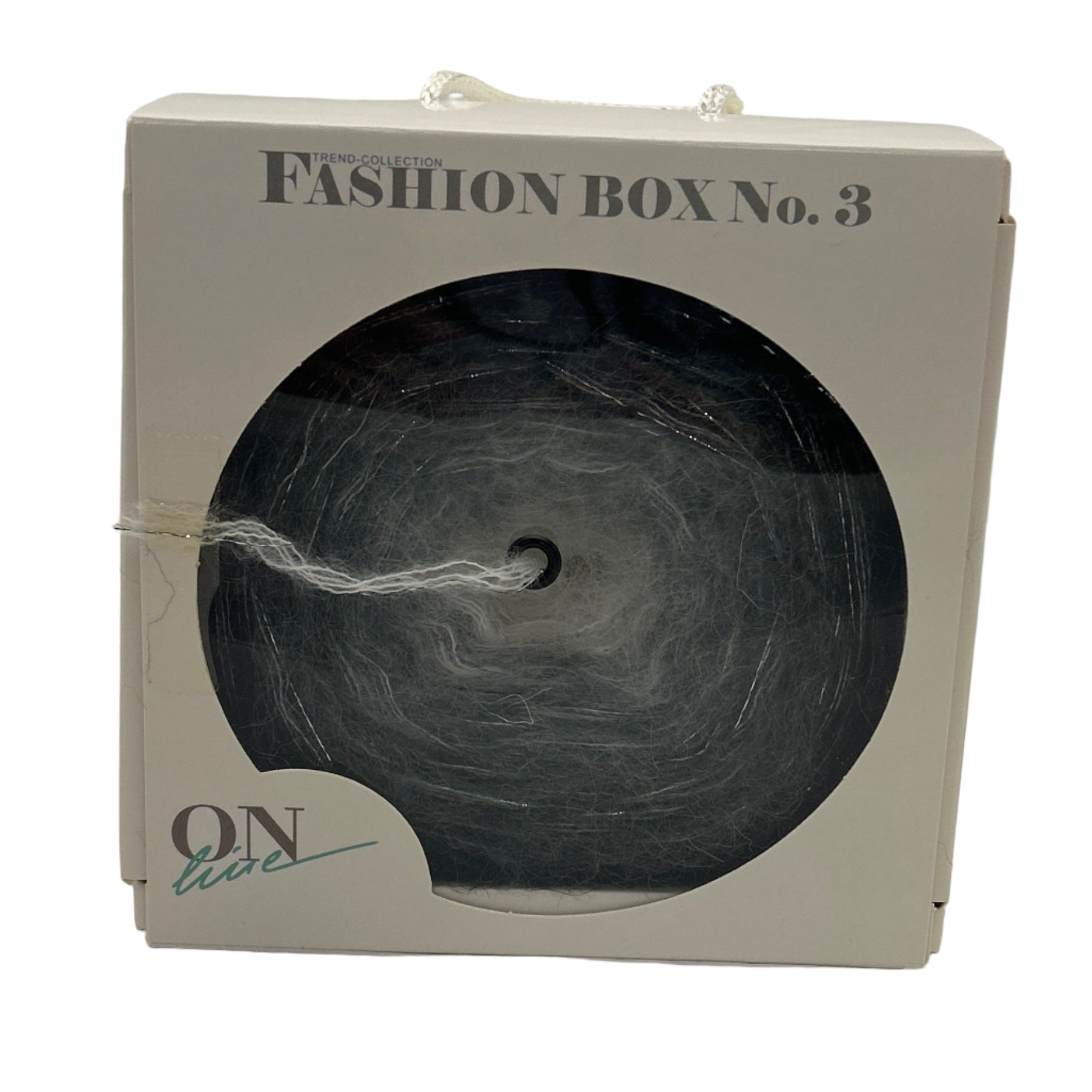 Fashion box labeled 'Fashion Box No. 3' with a black yarn ball inside on a white background
