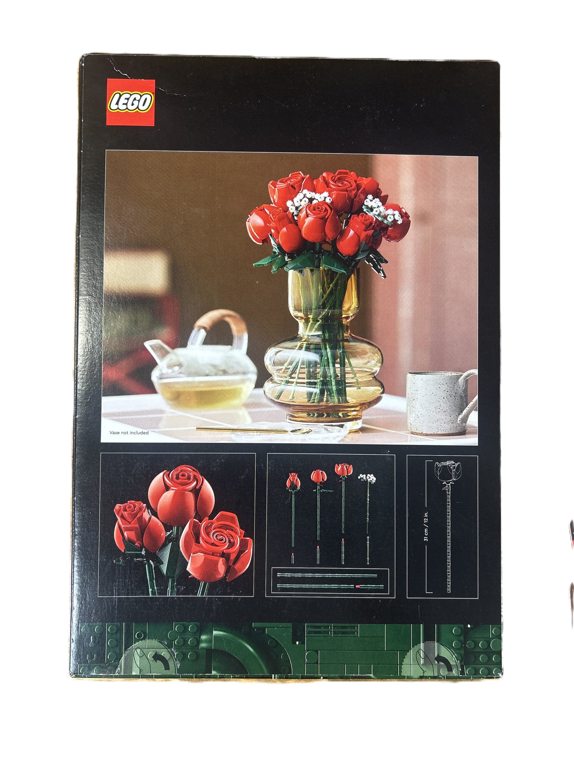 LEGO set packaging with red roses and a vase on a table
