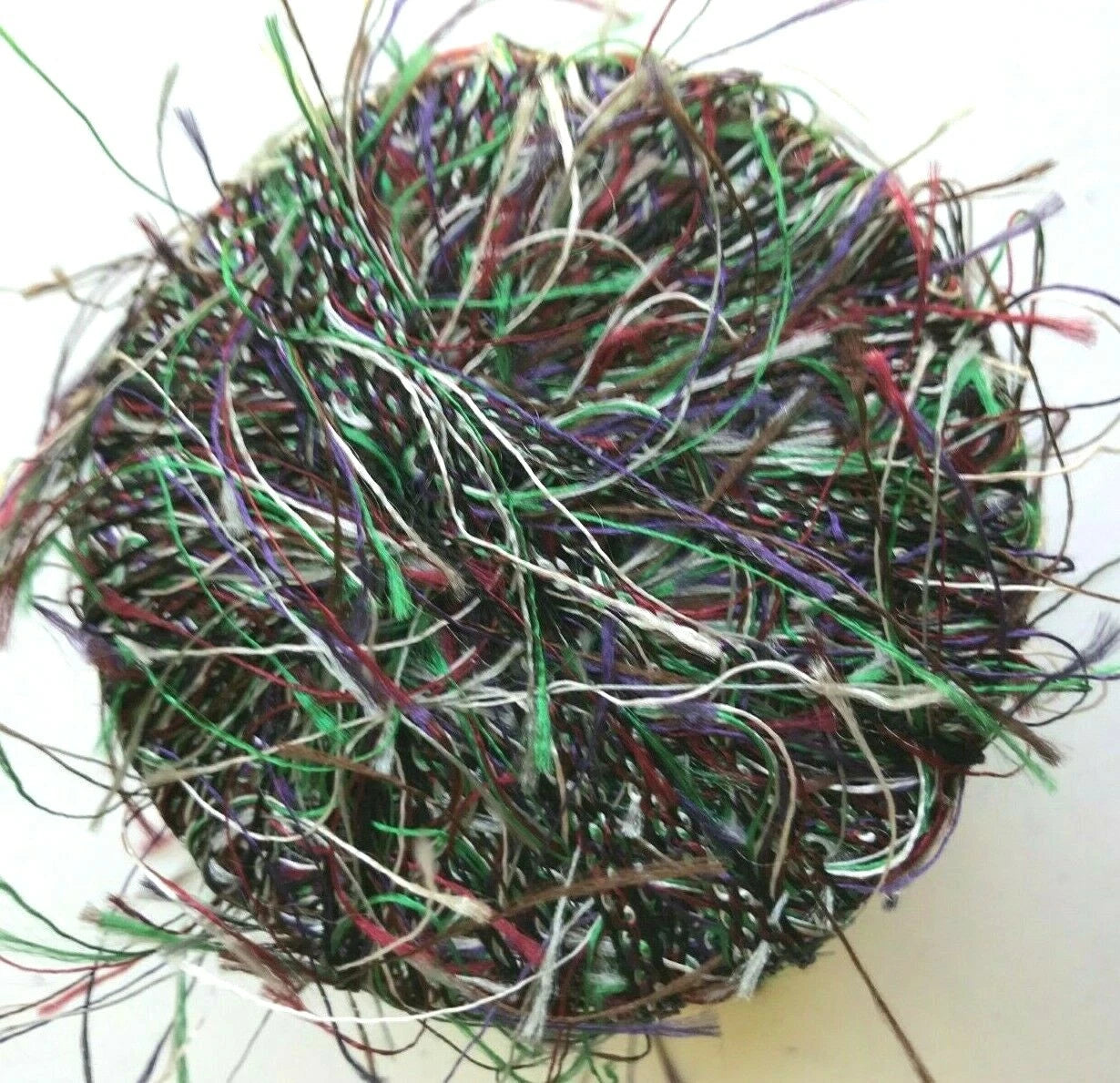 Ball of multicolored string or yarn on a white background