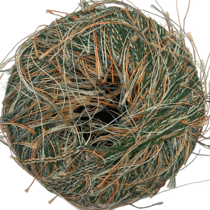Ball of twine with green and brown fibers on a white background